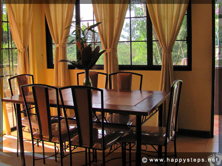 Mambukal Resort: Family Cottage - Dining area with glass doors offering a nice view of the outdoors