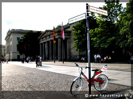 Photo of bicycle parked beside a sign post along Unter Den Linden Avenue, Berlin